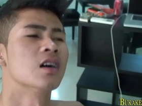 Asian twink gets a hot shower and a facial in a gay bukkake session
